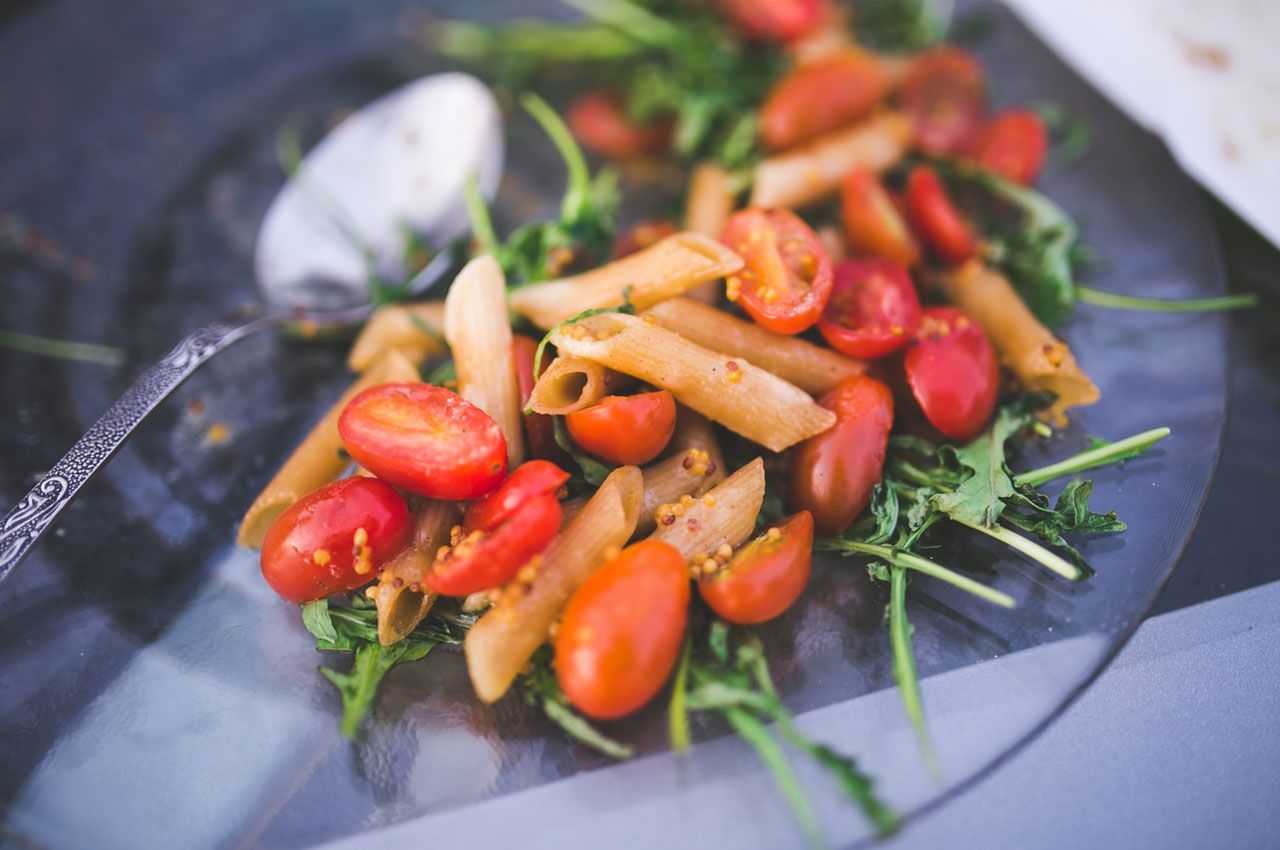 Freshly prepared tomato and arugula salad with a zesty dressing